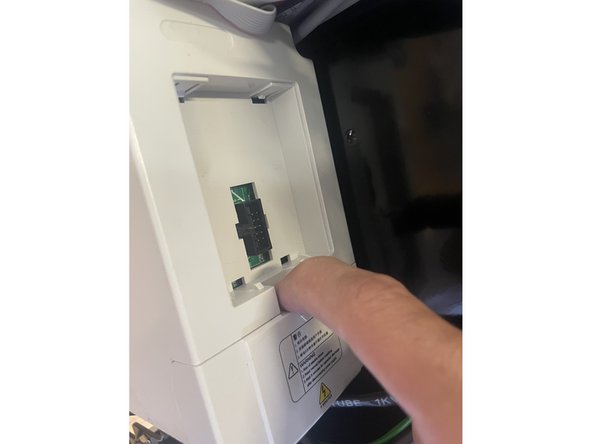 Remove the cover from the VFD by pulling on the tab in the middle of the lid.