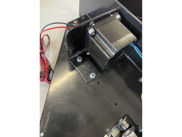 Remove the 2 screws holding the top motor inside the right gantry with the 3mm Allen Key and No 8 Spanner.