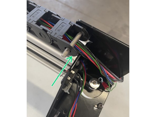 Slide the drag chain from the spindle assembly over the M6 screw with the cables below the screw.