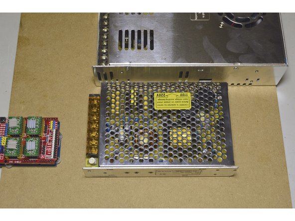 Use the M3x8 cap screws (2 Pcs) to fasten the power supply and use Pratley Pratlock on the screws.  Use the 2.5mm Allen Key to fasten the screws.