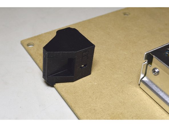 The lip of the printed part will stick over the edge of the board to keep it from rotating