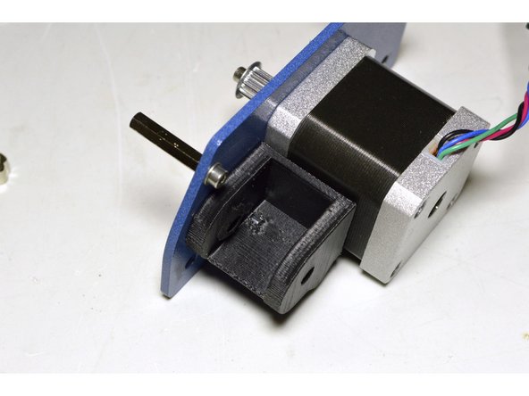 Mount the bracket with the M4x16 cap screw, M4 washer and Pratley Pratlock to the motor plate as shown