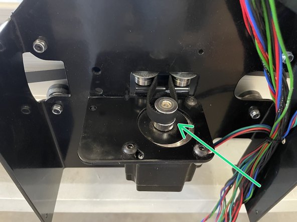 Take the end of the belt and feed it through the slot in the Belt Clamping Plate.  Fasten the belt to the front plate by clamping the belt between the Belt Clamping Plate and the Front Plate with 2 x M5x12 black button head cap screws and 2 x M5 lock nuts.