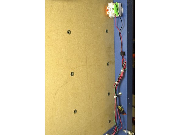 Use the Cable Clips with adhesive to mount the cables to the blue frame