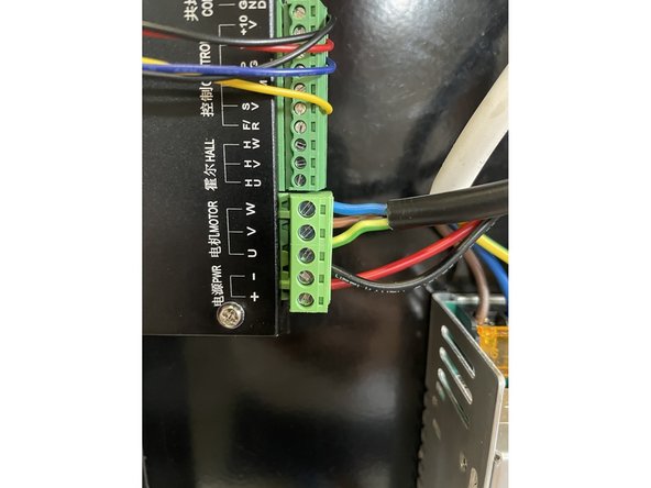 The blue wire goes to W.  The brown wire goes to V.  The green and yellow wire goes to U.