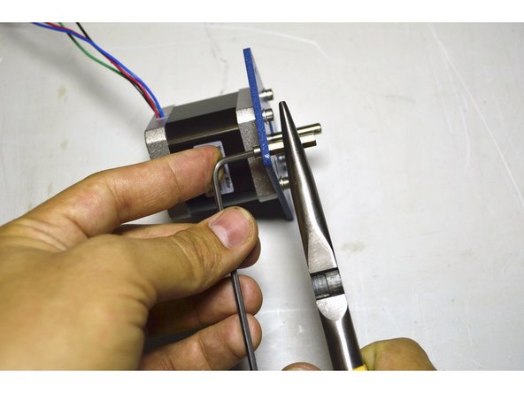 Hold the standoff with the sharp nose pliers while tighting the M3 cap screw with the 2.5mm Allen Key