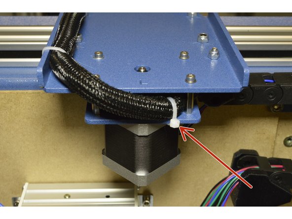 Use the Cable Ties (3 Pcs) and mount the X-Axis Cables to the Left Y-Carriage Plate as shown.  There are slots for all 3 cable ties in the blue plates