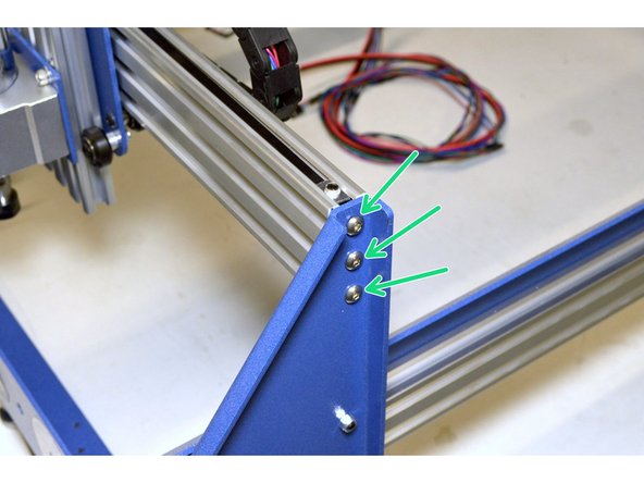 Insert the X-Axis Assembly in-between the Left and Right side plates with the spindle facing the Front Frame Plate