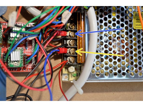Connect the black ground cable from the laser to one of the GND terminals on the 12V power supply.