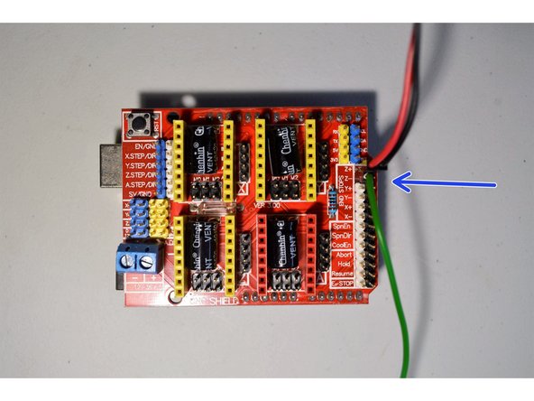 The green cable from the laser connector connects to the Z- pin.  Please note it connects to the white pin as shown.