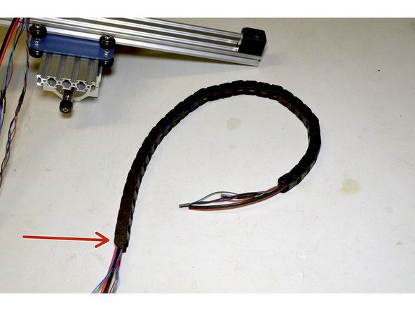 Slide the 10x10 Drag Chain over the 3 cables running from the spindle assembly with the side with the pins on the Drag Chain closest to the Spindle Assembly