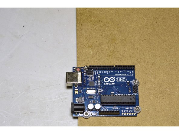 Mount the Arduino Uno with the M3x10 Cap Screws (4 Pcs) and the M3 Lock Nuts (4 Pcs) in the holes shown in red in the picture