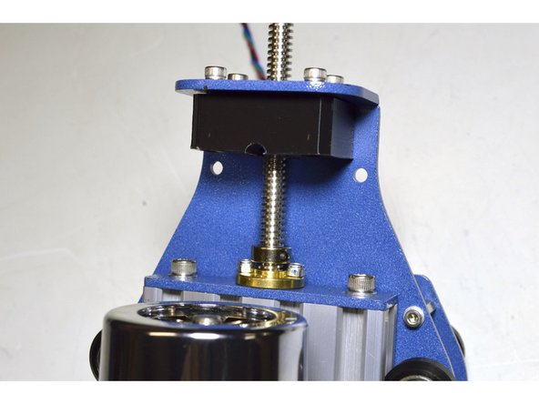 Insert the lead screw through the bearing block, through one 8mm Shaft Sleeve and screw it into the brass lead screw nut