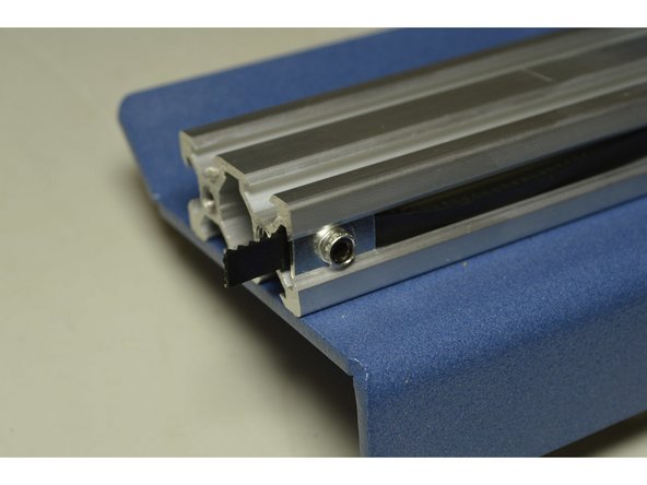 Clamp the end of the belt by screwing down the M5 grub screw with the 2.5mm Allen Key while pulling the end of the belt