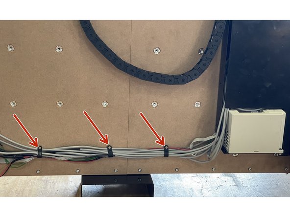 Tie the wiring down to the waste board(s) with the 4 x P-Clamps and 4 x 3x13mm Chipboard screws by screwing the chipboard screws into the waste board(s) with a phillips screw driver.  The wiring should run in a straight line from the Electronics Assembly to the Front Plate.