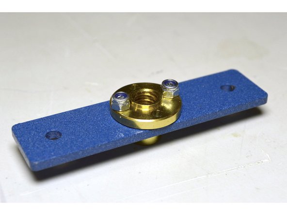 Fix the lead screw nut with the M3 lock nuts (2 Pcs) by using the flat screw driver and the sharp nose pliers