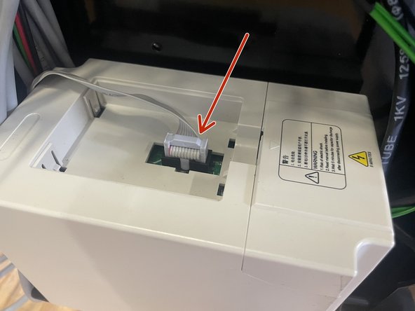 The VFD display on the front panel has a ribbon cable connected to it.  Connect the other side to the connector on the front of the VFD in the Electronics Assembly as shown in the picture.