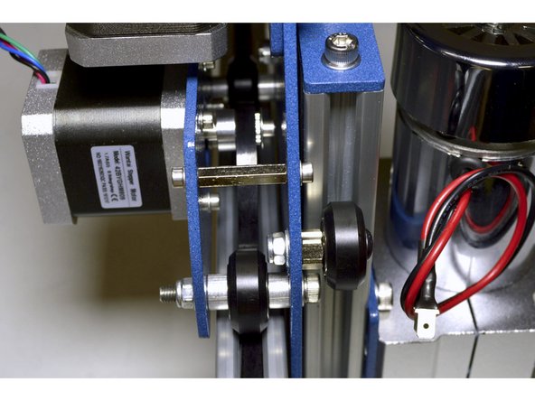 Slide the GT2 belt underneath one of the top X-Axis V-Wheels, over the GT2 Pulley and underneath the other V-wheel as shown