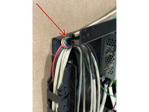 Route the Y-End stop cable through the same gap in the Electronics Assembly as the wires from the drag chain.