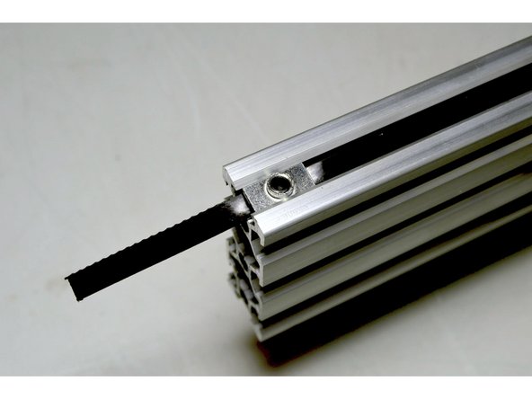 Fix the belt at the end with the M5 Plate Nuts (2 Pcs), M5x6 Grub Screw (2 Pcs) and Pratley Pratlock in the same way as previously