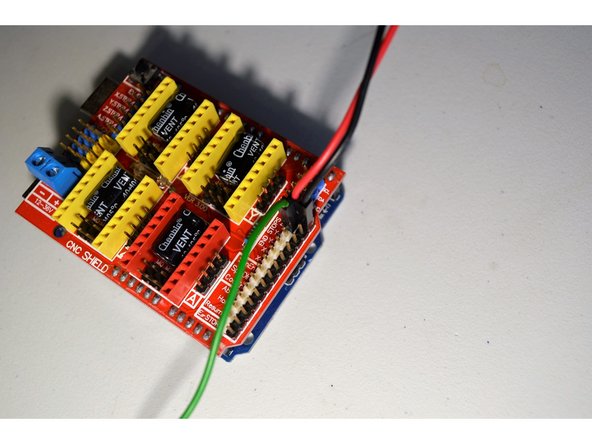 The green cable from the laser connector connects to the Z- pin.  Please note it connects to the white pin as shown.