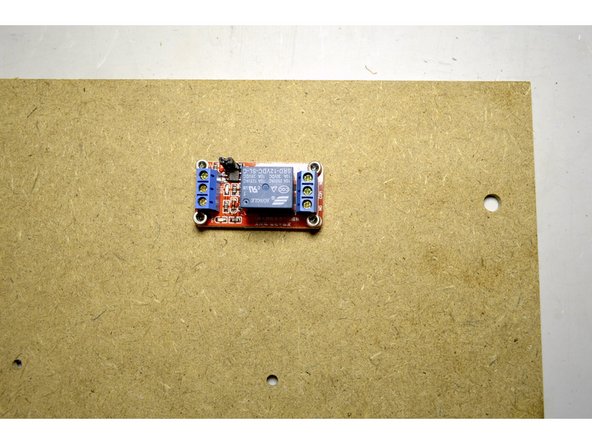 Mount the relay with the M3x10 Cap Screws (4 Pcs) and the M3 Lock Nuts (4 Pcs) in the holes shown in green in the picture