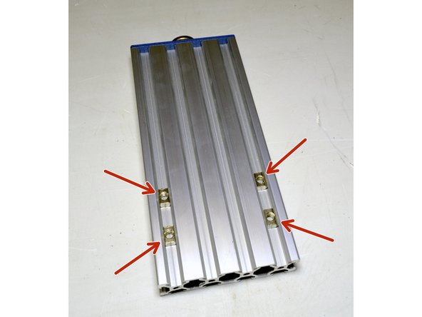 Slide the M5 T-Nuts (4 Pcs) into the two outer slots of the V-Slot profile as shown