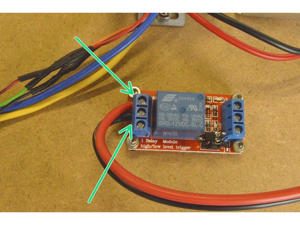 Take the Relay COM Cable and connect the end without the crimp terminal to the relay.  The red cable needs to be connected to the NO port and the black cable to the COM port as shown.