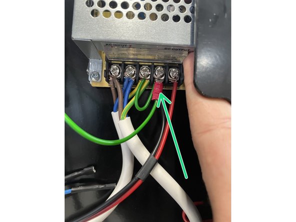 This can be done by loosening the screw of the earth connection with a Phillips Screw Driver.  Then sliding the fork terminal in below the plate in the connection and tightening the screw again.