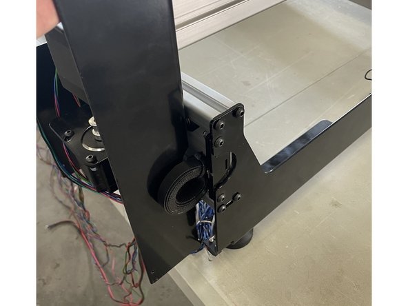 While the X-Gantry is against the back plate, tighten the 8 x M5x16 black button head cap screws.