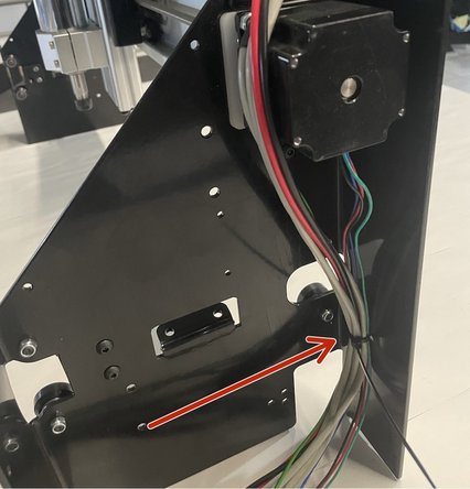 Route the cables through the right gantry as shown in the picture.  Tighten them with a cable tie to the back of the right gantry.