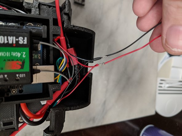 Solder the wires in parallel as shown in Pic 2.  Red to red, black to black and having it come out as a single red and black wire.