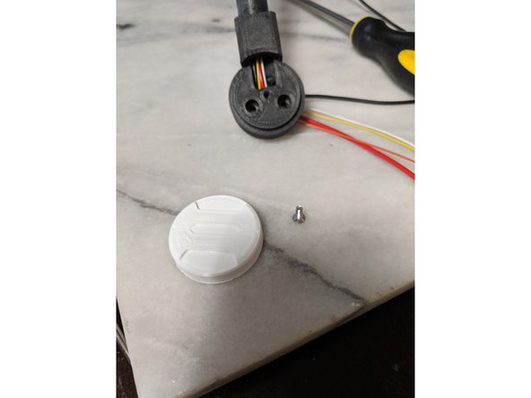 Insert a M3 Square nut into the nut trap which is located near where the wires make the bend you see in Pic 1.