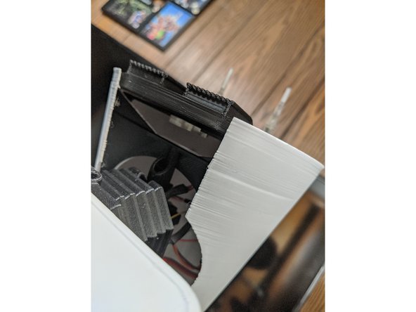 Take a M3 Square Nut and hold it with your finger into the notch of the LowerAerialBracket that can be seen from under the head  in Pic 1.  Hold the square nut in place with your finger.