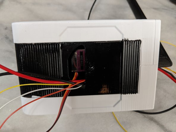 While sliding the HeadBoxB over the HeadBoxA, feed the wires through the hole.