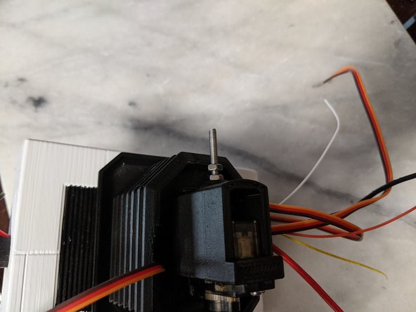 Tighten the first nut to secure the screw in place securely.