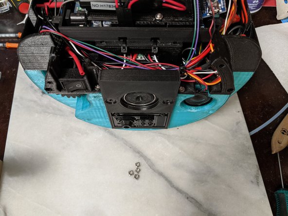 You will now install 4 M3 square nuts in the top frame.  Each side has 2 locations for them.