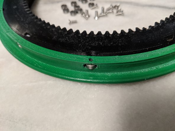 Insert the bearing into the slots on the side of the DriveEdge making sure they are in there somewhat loosely.  I used a dremel with a small router bit to clear out the opening to get them to fit looser.  Reference Pic 2.