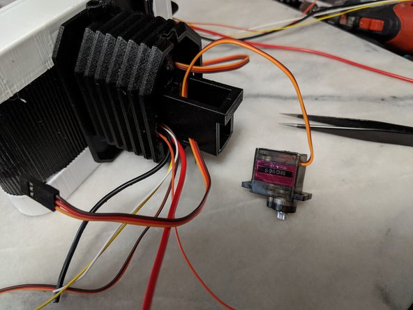 Feed the servo wires through the hole in the TopNeck print as shown in Pic 2.