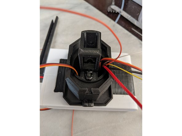 Looking at Pic 1 you can see to apply a small dab of epoxy on the servo horn and the TopNeck print.  Make sure not to put epoxy on the screw securing the servo horn to the servo so everything can still be removed if needed.