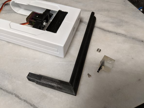 Once the epoxy has dried, remove the HeadBar, and remove the SeroCouple with the now epoxied on servo horn.  You will use the servo center screw that came with the servo and a M3 Square Nut.