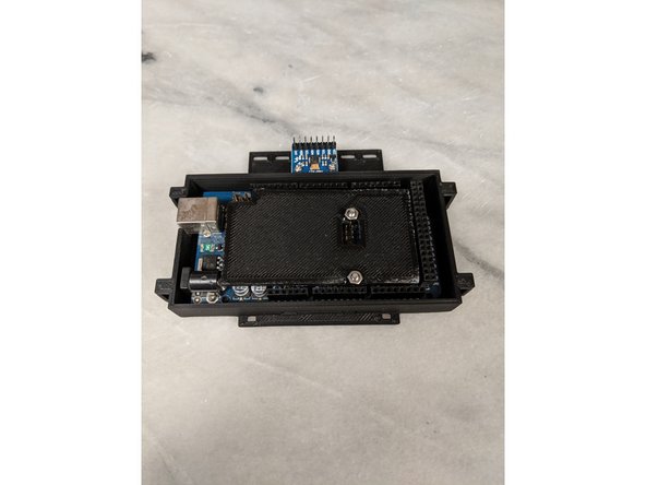 Place the Arduino Top on top of the Arduino lining up the cutout with the center pin header as shown in Pic 2.