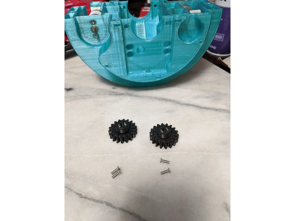 First thing we will do is insert the square nuts into the PololuGear prints as shown in Pic 2.