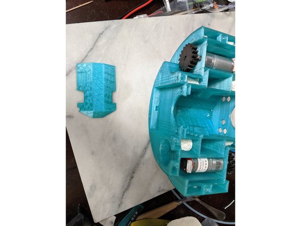 This step is fairly simple.  Take the ServoBase print, and insert it into the center of the frame.