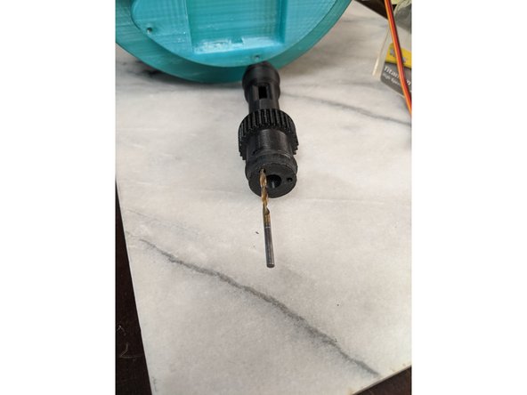 The first thing you want to do is drill the 3 holes out as shown in Pic 2 using a 1/8 inch drill bit.  The holes are capped for easier printing and making the nut traps cleaner, so they must be drilled out.