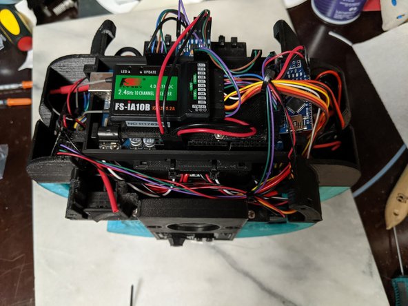 Now is the time to clean up any wiring in the top frame.  You want to make sure the wires are tight to the top of the the frame and secured as cleanly as possible so they do not get caught on the gear of the lazy susans when in motion. The wires near the IMU are ones particular that need to be as close to the frame as possible.