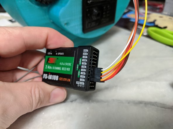 The center servo with the power wires goes go channel 3.  The remaining servo signal wires will be channels 4, 5, and 6.  Use pic 2 as reference.