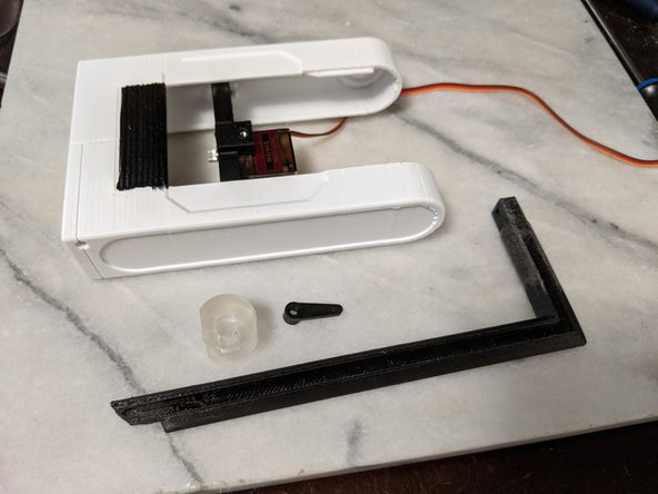 Here you will be using the servo horn, the ServoCouple print, the HeadBar print, and the Headbox from previous steps.