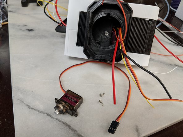 Here we will use another MG90S servo and the two mounting screws that come with the servo.  Also you will want the single servo horn and machine screw that comes with the servo as well.