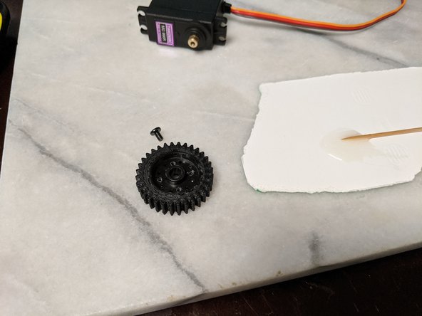 Insert the servo gear attachment all the way into the MainServoGear to epoxy the attachment to the inside of the gear. I used a screwdriver to make sure the servo attachement was all the way inserted and flush inside the gear as shown in Pic 3.